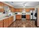 Traditional kitchen with wooden cabinets, white countertops, and stainless-steel appliances at 142 Old Hampton Way, Hampton, GA 30228