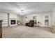 Bright living room with a fireplace, built-in shelving, and a comfortable leather recliner at 142 Old Hampton Way, Hampton, GA 30228