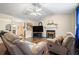 Bright living room showcasing hardwood floors, a fireplace, ceiling fan, and an open layout at 142 Old Hampton Way, Hampton, GA 30228