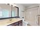 Bathroom with a large mirror, single sink, bath/shower combination, and neutral color scheme at 205 Kestrel Cir, Covington, GA 30014