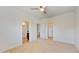 Bright bedroom with neutral carpeting, a ceiling fan, and access to the closet and bathroom at 205 Kestrel Cir, Covington, GA 30014