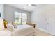 Comfortable bedroom with a window, white walls, and modern ceiling fan at 205 Kestrel Cir, Covington, GA 30014