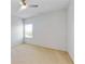 Bedroom has a large window providing an abundance of natural light, and neutral walls with carpeted floor at 205 Kestrel Cir, Covington, GA 30014