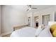 A bright bedroom with a ceiling fan, white walls, and a view to an en-suite bath and walk-in closet at 205 Kestrel Cir, Covington, GA 30014