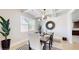 Well-lit dining area with modern lighting fixture, table seating for six, and a decorative mirror at 205 Kestrel Cir, Covington, GA 30014
