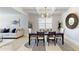 Well-appointed dining room with a modern light fixture and seamless flow to the adjacent living area at 205 Kestrel Cir, Covington, GA 30014