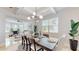 Bright and airy dining room showcasing a modern light fixture and view into the adjacent living space at 205 Kestrel Cir, Covington, GA 30014