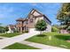 Two story home with brick facade, a two-car garage, and a well-maintained lawn at 205 Kestrel Cir, Covington, GA 30014