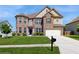 Traditional brick home with manicured lawn, featuring a two-car garage and a driveway, under a clear sky at 205 Kestrel Cir, Covington, GA 30014