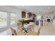 A bright kitchen with dark wood cabinets, stainless steel appliances, a kitchen island, and an adjacent breakfast nook at 205 Kestrel Cir, Covington, GA 30014