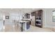 Open-concept kitchen with a large island, stainless steel appliances, dark wood cabinets, and modern lighting at 205 Kestrel Cir, Covington, GA 30014