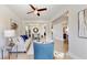 Bright and airy living room with modern decor, featuring a ceiling fan, tile floors, and a view into the dining area at 205 Kestrel Cir, Covington, GA 30014