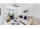 Bright living room with ample natural light, neutral furniture, and a ceiling fan for added comfort at 205 Kestrel Cir, Covington, GA 30014