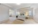 Bright main bedroom featuring neutral walls, carpeted floors, and a doorway to a dedicated office space at 205 Kestrel Cir, Covington, GA 30014