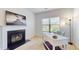 Bright office space with a decorative fireplace and mantle, view to the outdoors, and dedicated lighting at 205 Kestrel Cir, Covington, GA 30014