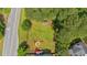 Aerial view of a lush green homesite with mature landscaping and a fire pit area at 21 Collins Dr, Douglasville, GA 30134