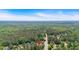 Aerial view of a home nestled in a lush, established wooded neighborhood with mature landscaping at 21 Collins Dr, Douglasville, GA 30134