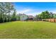 Large, well-maintained backyard offers ample space for outdoor activities and features a deck, mature trees, and lush greenery at 21 Collins Dr, Douglasville, GA 30134