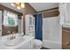 Bathroom shows white tile bathtub, matching white toilet and sink, and brown painted walls at 21 Collins Dr, Douglasville, GA 30134