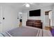 Bedroom with ceiling fan, TV, dresser, and adjacent bathroom and doorway access at 21 Collins Dr, Douglasville, GA 30134