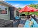Relaxing outdoor deck with comfortable blue cushioned seating, stylish rug, and convenient grill, perfect for entertaining guests at 21 Collins Dr, Douglasville, GA 30134