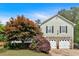 Charming two-story home featuring stone accents, a well-manicured lawn, and an attached two-car garage at 21 Collins Dr, Douglasville, GA 30134