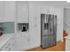 White kitchen cabinets with stainless steel refrigerator and built in coffee station at 21 Collins Dr, Douglasville, GA 30134