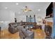 Bright living room with a large sectional sofa and fireplace with stone surround at 21 Collins Dr, Douglasville, GA 30134