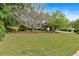 Spacious front yard with mature trees and well-maintained lawn, creating an inviting and picturesque curb appeal at 21 Collins Dr, Douglasville, GA 30134