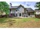 Expansive backyard features a patio area, lush lawn, and mature trees, perfect for outdoor living at 3186 Sail Winds Nw Dr, Acworth, GA 30101