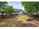 The backyard features a well-manicured lawn with mature trees providing ample shade at 3186 Sail Winds Nw Dr, Acworth, GA 30101