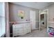 Carpeted bedroom featuring natural light and a charming doorway leading to the laundry room at 3186 Sail Winds Nw Dr, Acworth, GA 30101