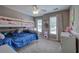 Inviting bedroom featuring a bunk bed, large windows and carpet creating a cozy and functional living space at 3186 Sail Winds Nw Dr, Acworth, GA 30101