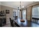 Dining room with a large wooden table, modern chandelier, and access to the foyer at 3186 Sail Winds Nw Dr, Acworth, GA 30101