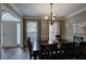 Open dining room with hardwood floors, dark wood table, neutral walls, and natural light at 3186 Sail Winds Nw Dr, Acworth, GA 30101