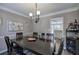 Dining room featuring a dark wooden table, modern decor, and easy access to the kitchen at 3186 Sail Winds Nw Dr, Acworth, GA 30101