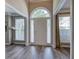 Inviting foyer with hardwood floors, arched window above the door, and neutral wall colors at 3186 Sail Winds Nw Dr, Acworth, GA 30101