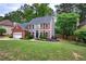 Well-manicured lawn and landscaping accent this two-story home with attached garage at 3186 Sail Winds Nw Dr, Acworth, GA 30101