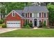 Charming brick home with a well-manicured lawn, two-car garage, and mature trees at 3186 Sail Winds Nw Dr, Acworth, GA 30101