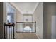 Hallway with decorative railing, chandelier, and arched window providing natural light to upper level at 3186 Sail Winds Nw Dr, Acworth, GA 30101