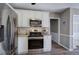 Well-lit kitchen features stainless steel appliances, granite countertops, and white cabinets at 3186 Sail Winds Nw Dr, Acworth, GA 30101