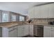 Kitchen featuring white cabinets, granite countertops, and stainless steel appliances at 3186 Sail Winds Nw Dr, Acworth, GA 30101