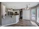 Eat-in kitchen with stainless appliances, white cabinetry and granite countertops at 3186 Sail Winds Nw Dr, Acworth, GA 30101