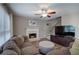 Living room featuring comfortable seating, a ceiling fan, fireplace, and natural lighting at 3186 Sail Winds Nw Dr, Acworth, GA 30101