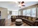 Open-concept living room includes a large sofa, ceiling fan, and easy access to the kitchen at 3186 Sail Winds Nw Dr, Acworth, GA 30101