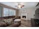 Cozy living room showcasing a fireplace, comfortable seating, and a ceiling fan at 3186 Sail Winds Nw Dr, Acworth, GA 30101
