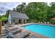 Community pool with lounge chairs, umbrellas, and a nearby cabana area, creating an inviting atmosphere at 3186 Sail Winds Nw Dr, Acworth, GA 30101
