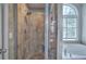 Elegant tiled shower with glass door and soaking tub adjacent at 3186 Sail Winds Nw Dr, Acworth, GA 30101