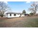 Backyard view showcasing the house, covered area, and expansive lawn space at 4605 Doss Cir, Powder Springs, GA 30127
