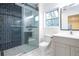 Modern bathroom featuring a glass-enclosed shower with stylish tile and a vanity with sink at 4605 Doss Cir, Powder Springs, GA 30127